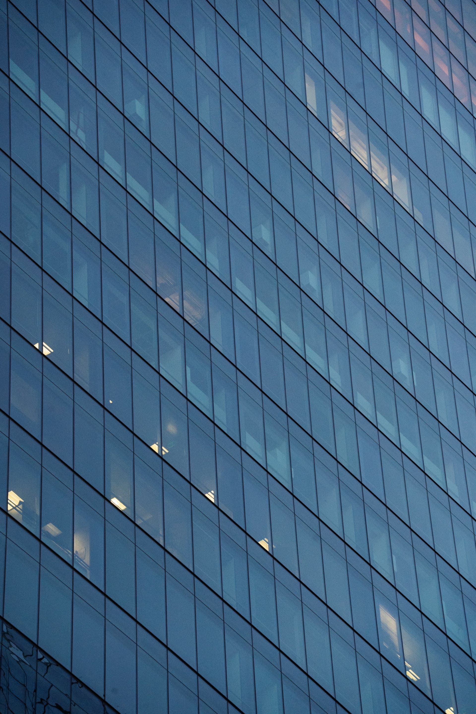 Blue glass facade of a modern commercial office building